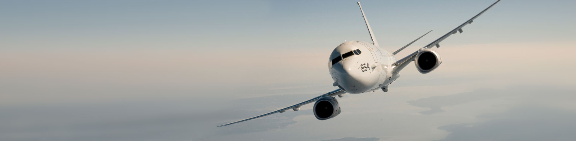 P8 front view in flight over land and water 